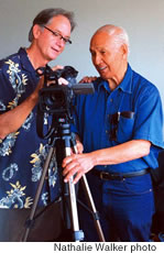 Dennis Mahaffay shows Eddie Kamae a shot in the viewfinder