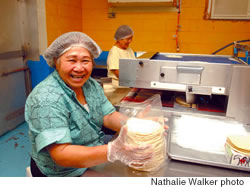 Esperanza Ascuncio (foreground) and Marcosa Valleramos prepare corn tortillas for packing