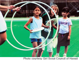 Girls at last year’s National Girls and Women in Sports Day try their hand at ultimate frisbee