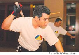 Abraham Rosario (front) and Anthony Tanare (back) work on perfecting their stick technique