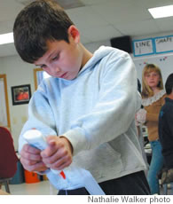 Hannah Noshioka, third grade, and Fin Merrill, second grade, work on art projects