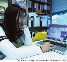 Laura Matsuo listens to a podcast on her laptop computer