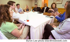 Interviewers Jennifer Salyers and Scott Salyers, left, listen to Barry Allison, blue shirt, as Robert Murray, Jessica Duncan, Michael Forshey, Alim Shabazz, Christie Wagner-Starley and Heather Sullivan listen