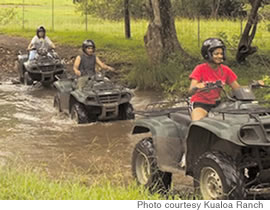 Riders splash through one of the ranch’s streams