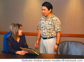 Hard at Work: Atlas Unit manager Lynne Shimizu and VPO Lance Kawano discuss data on hurricane insurance