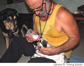 Fred Coury feeds Jimbo as a friend looks on