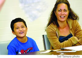 Noah Ellis and his mom, Heather, smile while Chock shows off one of her tricks