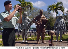 Sgt. James Sproul plays Taps at a funeral for a fallen comrade