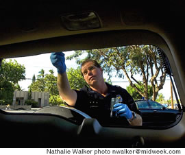 Officer Zane Hamrick dusts for fingerprints