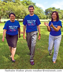 Donna Tanoue and Al Landon of Bankoh walk with Connie Mitchell of IHS, right