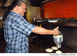  Chef Carsie Green uses a pancake gun at Cinnamon’s