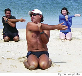 Doing some pre-swim stretching are (from left) Dustin Sharp, John Kobelansky and Christine Radcliffe