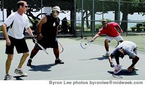 Matthew Robinson returns a shot as Cesar Cuadros ducks and Bill Kowalski and Rod Felton watch