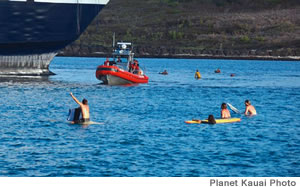 Surfers waylay the Superferry in Nawiliwili Harbor