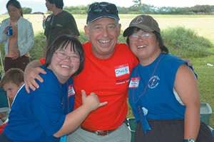 Charlie Jones Jr. with two participants from Special Olympics Hawaii