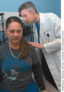 Dr. Sewell checks out a patient at Kaiser Permanente's Mapunapuna clinic