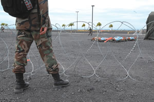 Behind razor wire, dead bodies await processing