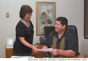 Jim Donovan and his secretary Margie Okimoto go over his busy schedule for the day