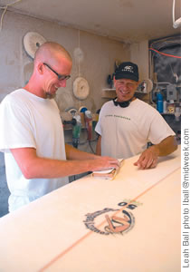 Kyle Bernhardt and Jeff Bushman work on an environmentally friendly board