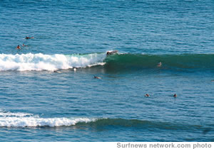 Monday evening on the last day of June was glassy and perfect. A surfer sweeps into Threes break. This beautiful view is from the Hawaii Prince Hotel