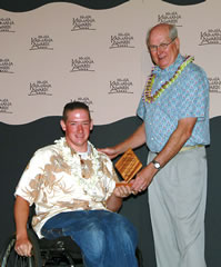 Kahuku High’s Joseph Broc receives his scholarship plaque from HMSA senior vice president Cliff Cisco at the Kaimana Awards & Scholarship luncheon June 17 at Koolau Golf Club. Photo from Chance Gusukuma.